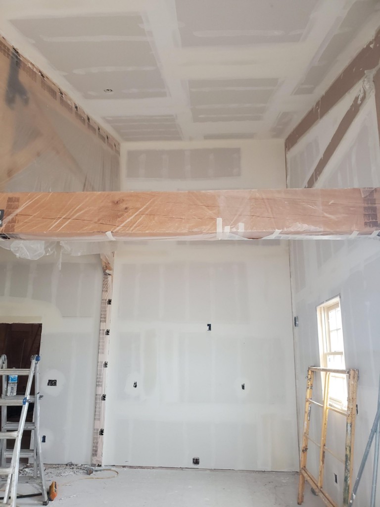 Drywall repair and finishing around a wood beam in a country home